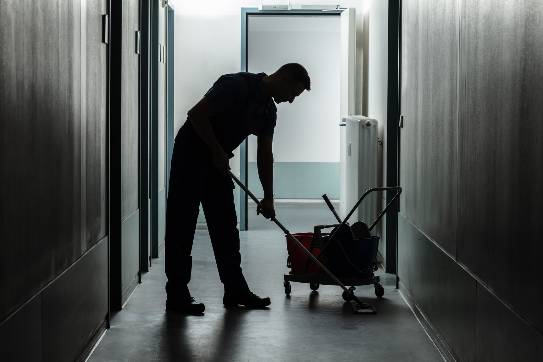 Male Janitor Cleaning Corridor